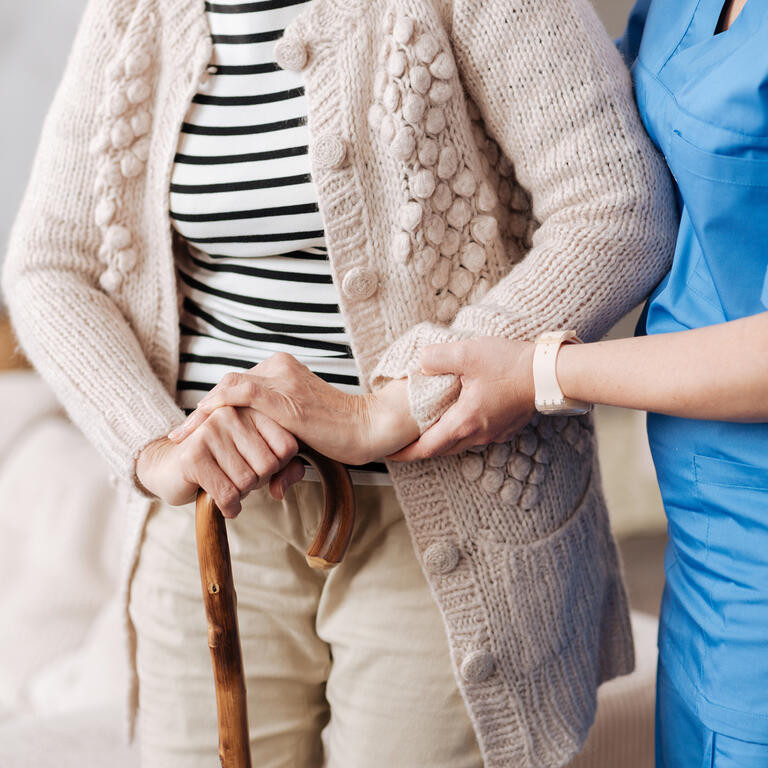 oldwoman helped by nurse