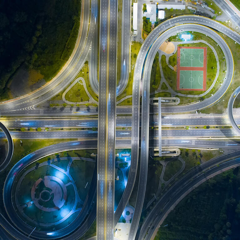 The light on the road roundabout at night and the city in Bangkok, Thailand. Aerial view. Top view. Background scenic road.