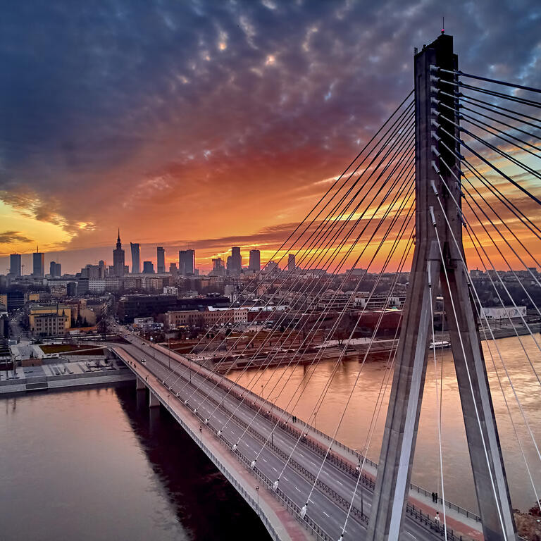 Beautiful panoramic aerial drone sunset view to Warsaw city center with skyscrapers and Swietokrzyski Bridge (En: Holy Cross Bridge)