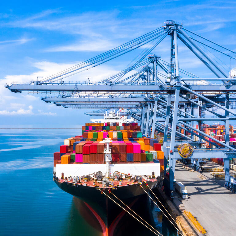 Aerial view container cargo ship freight shipping unloading at original destination port with quay crane, Business commercial global oversea logistic import export container box by container vessel