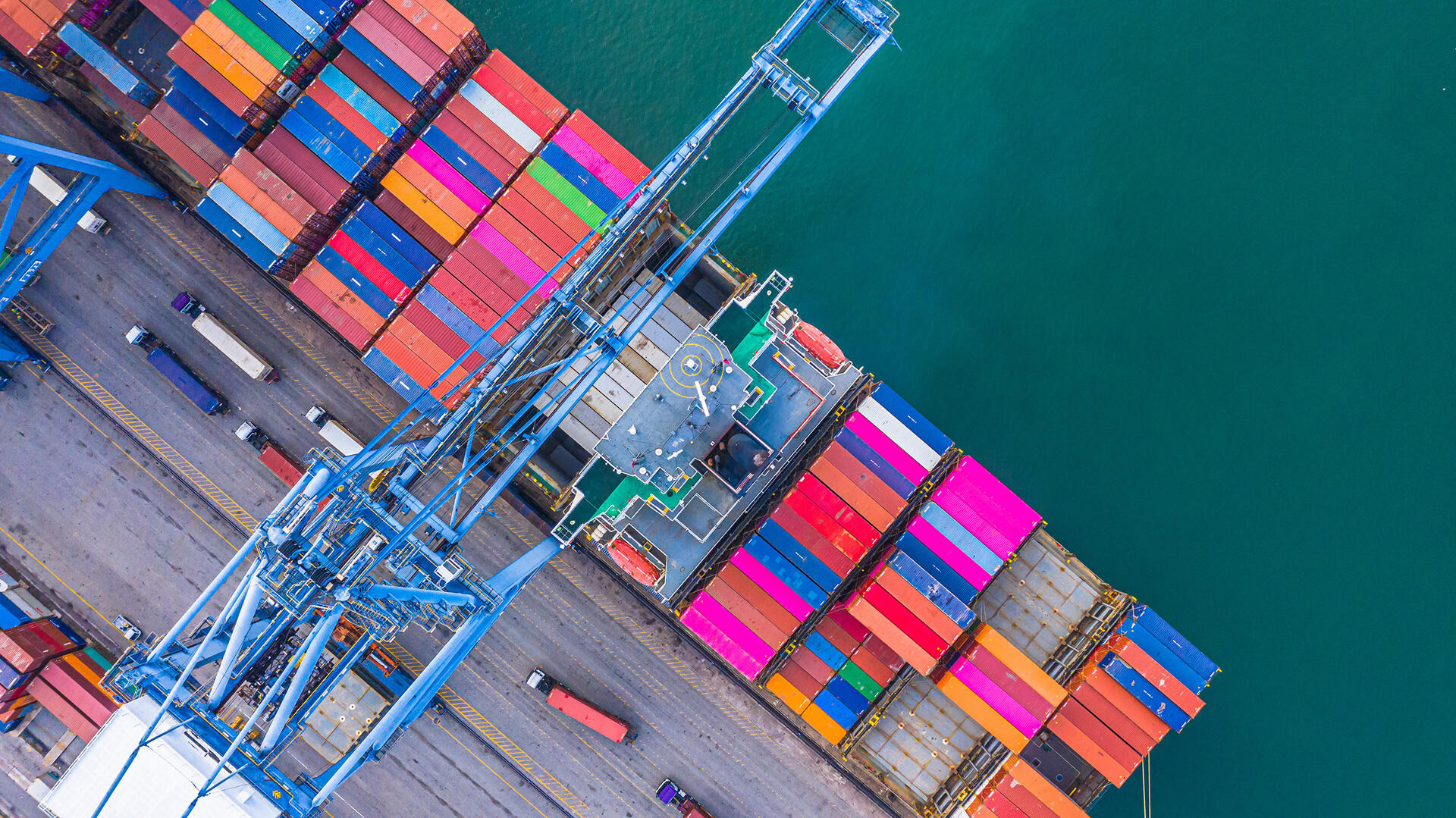 Container ship loading and unloading in deep sea port, Aerial top view of logistic import export transportation business by container ship in open sea